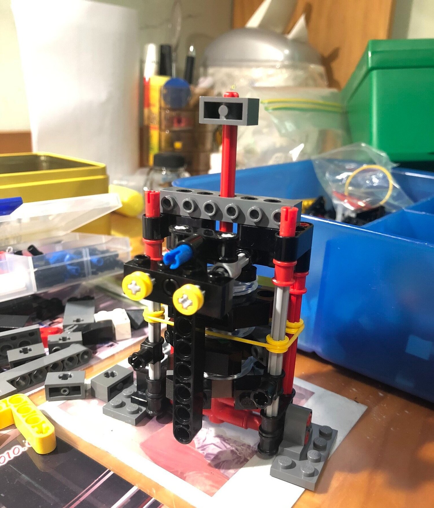 This is the first prototype. I used the yellow rubber band to put some damping onto the middle disk (blue disk in first picture), so that it will stay in position when stopper is released.